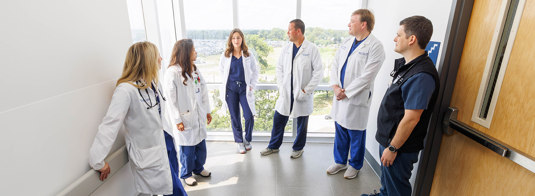 A group of hospitalists convene for a patient care discussion.